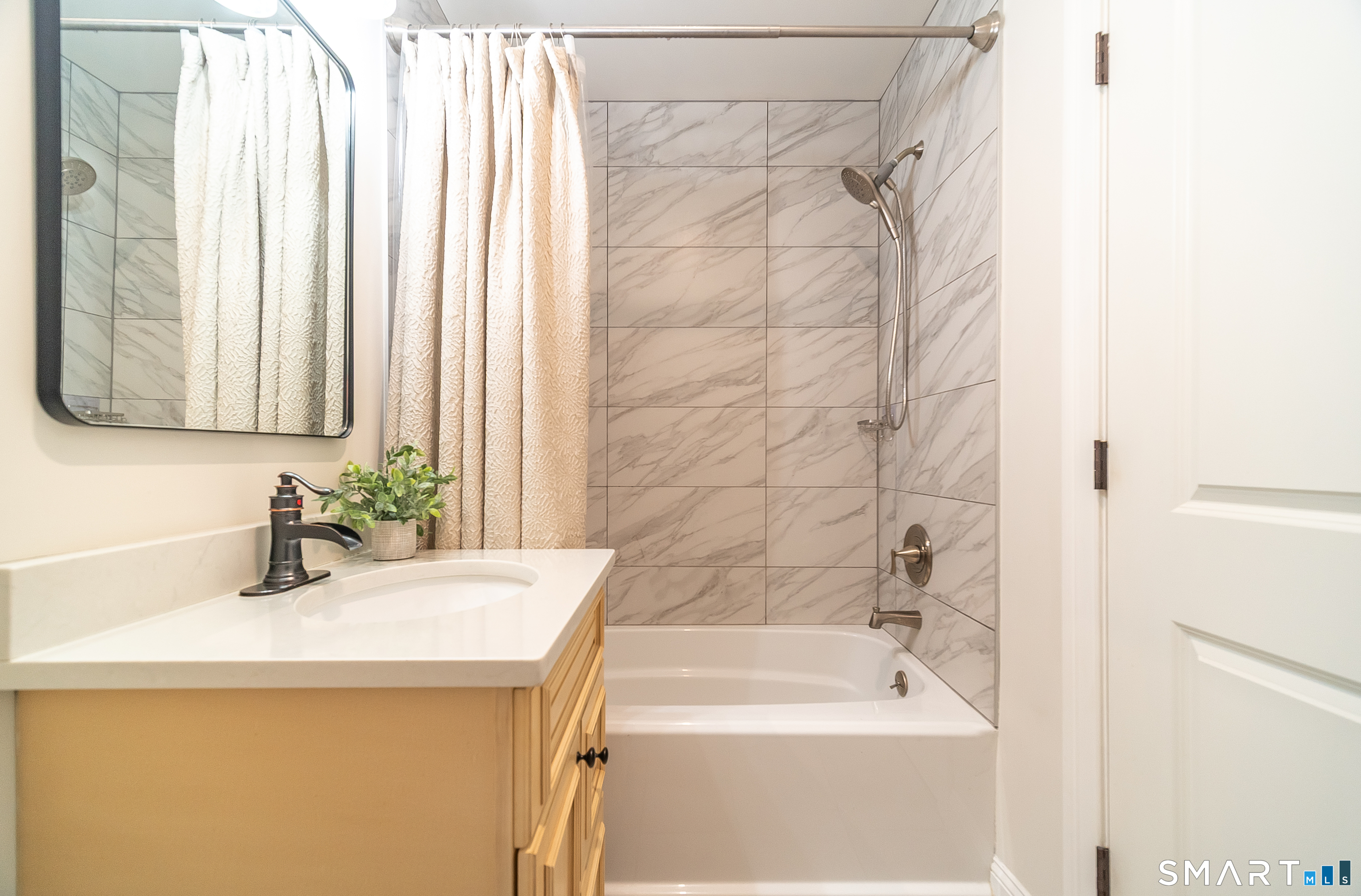 69 Cronin Street Bristol, CT 06010 - Photo 19 of 40 a bathroom with a sink and a bathtub