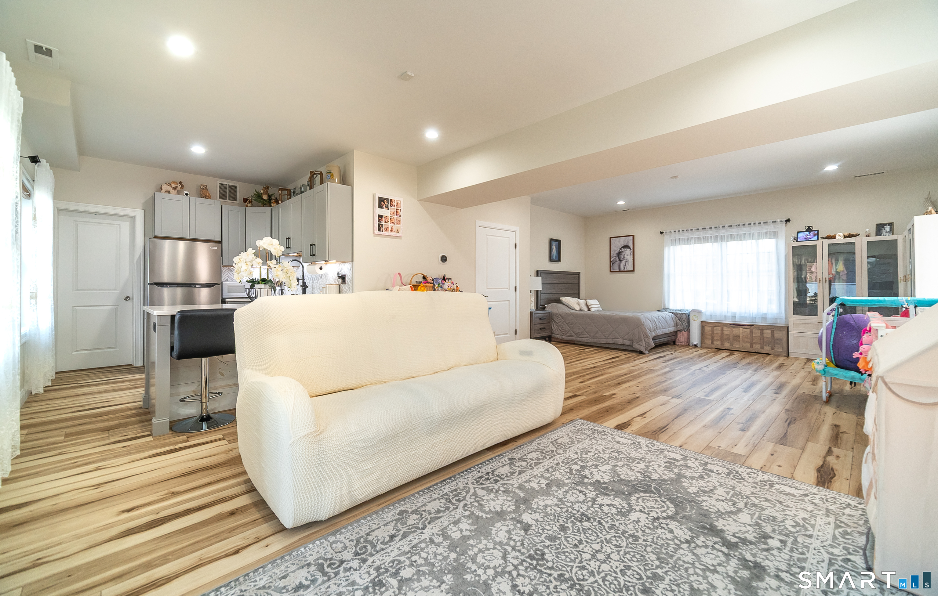 69 Cronin Street Bristol, CT 06010 - Photo 22 of 40 a living room with furniture and a dining table with wooden floor