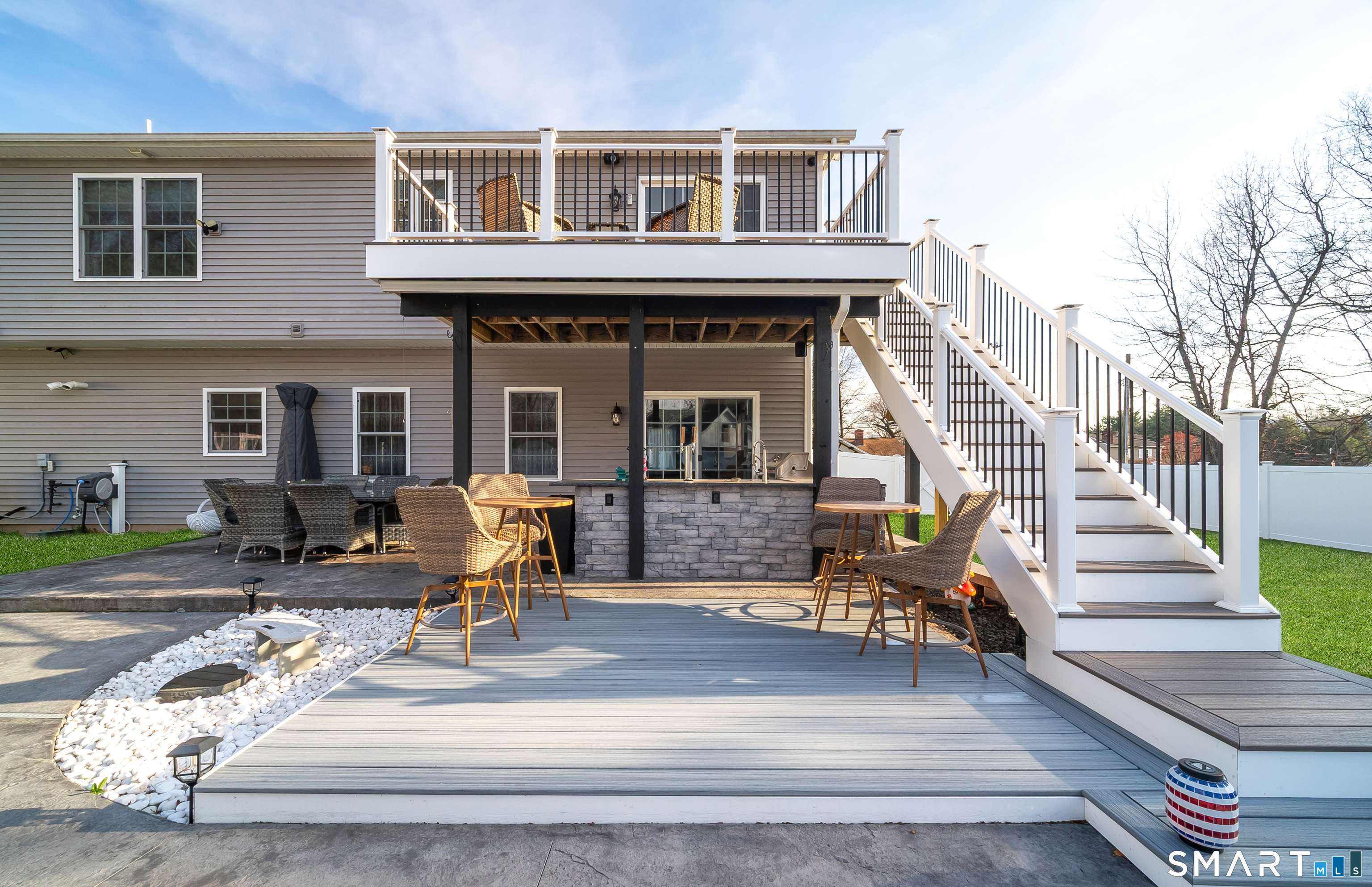 69 Cronin Street Bristol, CT 06010 - Photo 30 of 40 a view of a patio with couches table and chairs with wooden floor and fence