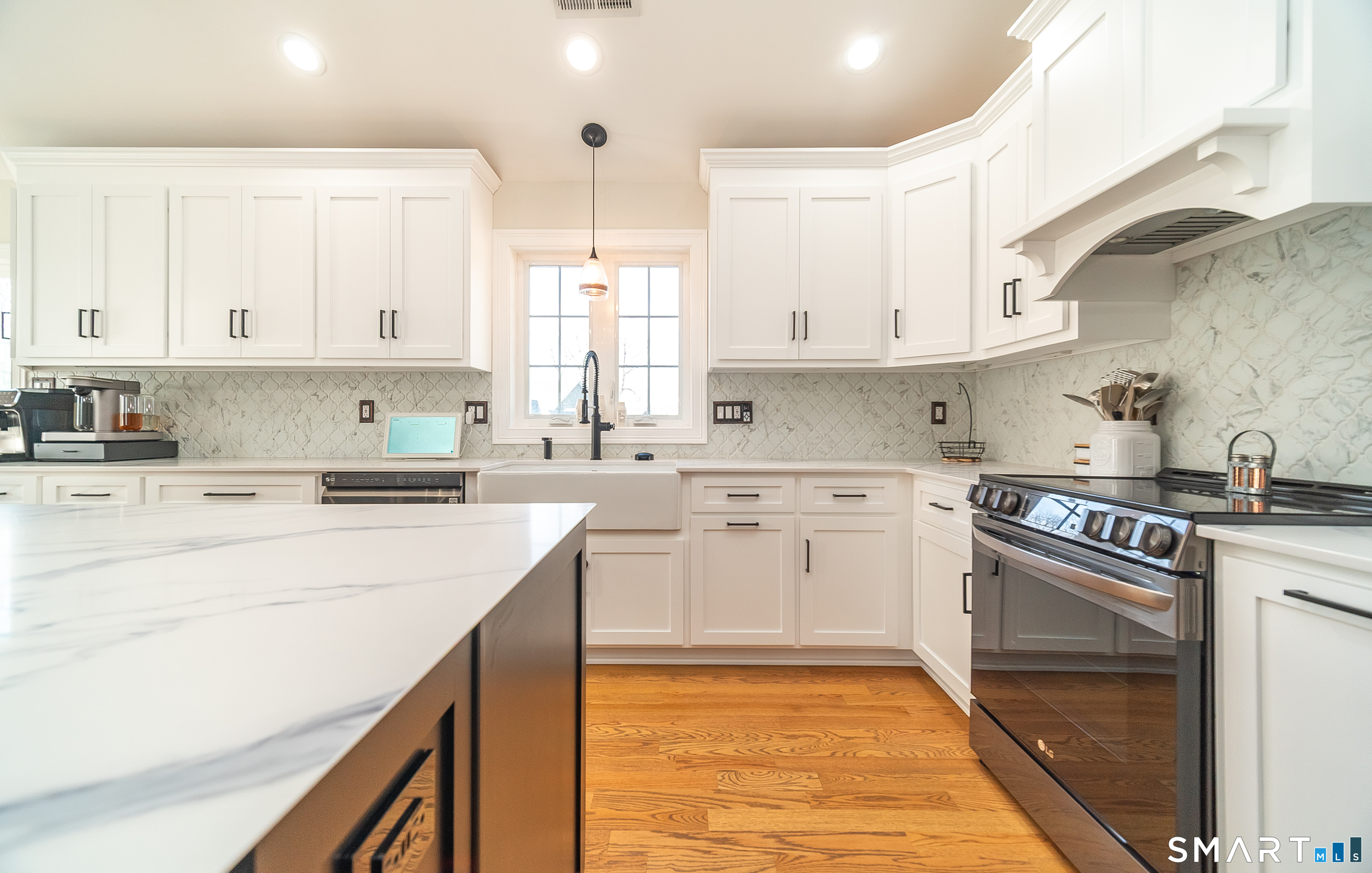 69 Cronin Street Bristol, CT 06010 - Photo 3 of 40 a kitchen with cabinets appliances and a window