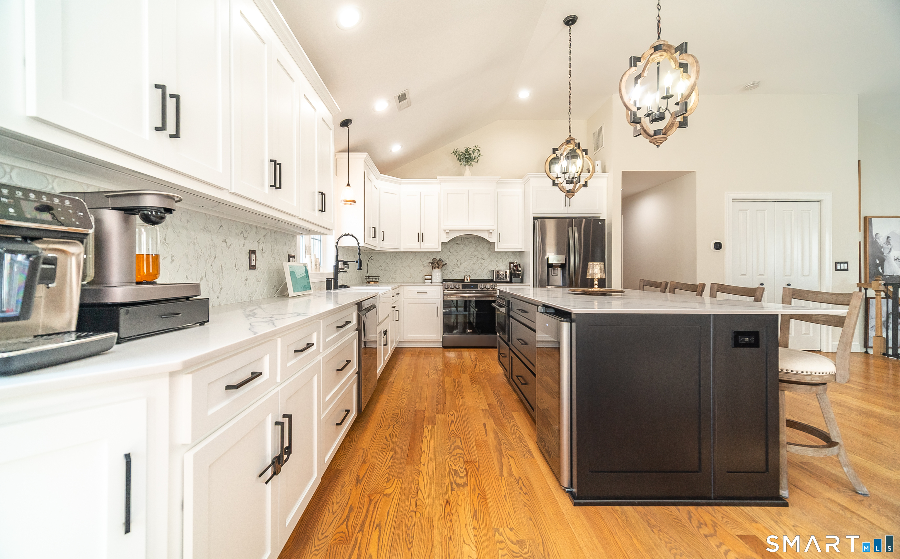 69 Cronin Street Bristol, CT 06010 - Photo 4 of 40 a large kitchen with kitchen island white cabinets and stainless steel appliances