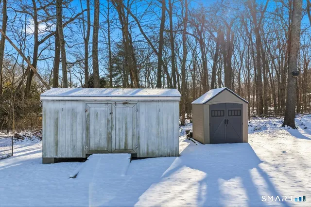 a view of a house with a yard covered in snow