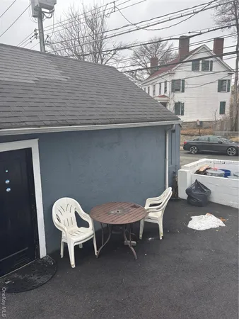 a couple of chairs sitting in backyard of a house