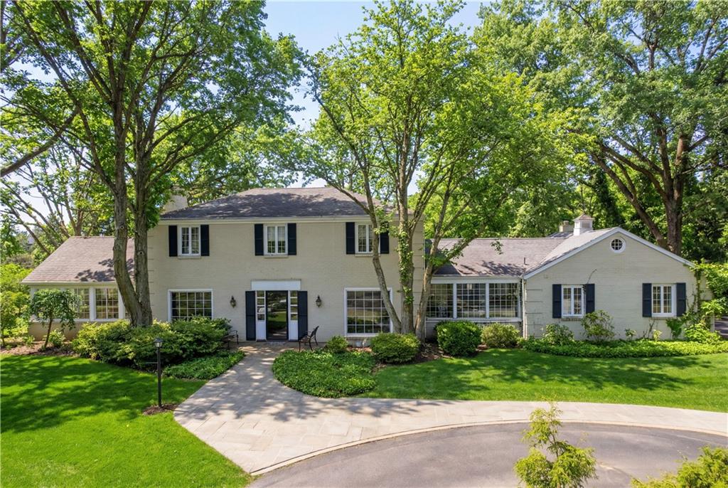 1001 Fox Chapel Road Pittsburgh, PA 15238 - Photo 2 of 50 a view of a yard in front of a house with plants and large trees