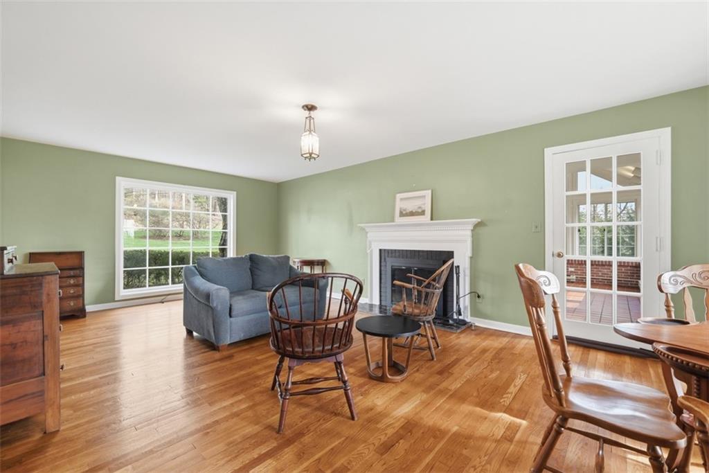 1001 Fox Chapel Road Pittsburgh, PA 15238 - Photo 25 of 50 a dining room with furniture a fireplace and wooden floor