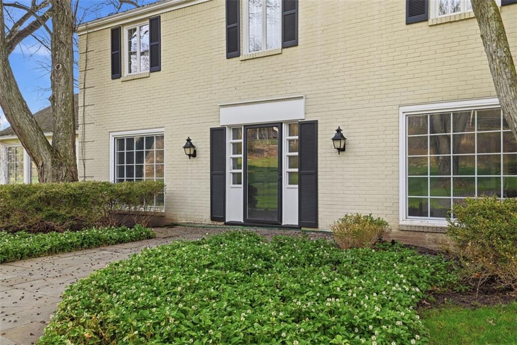 1001 Fox Chapel Road Pittsburgh, PA 15238 - Photo 3 of 50 a front view of a house with a yard and glass windows