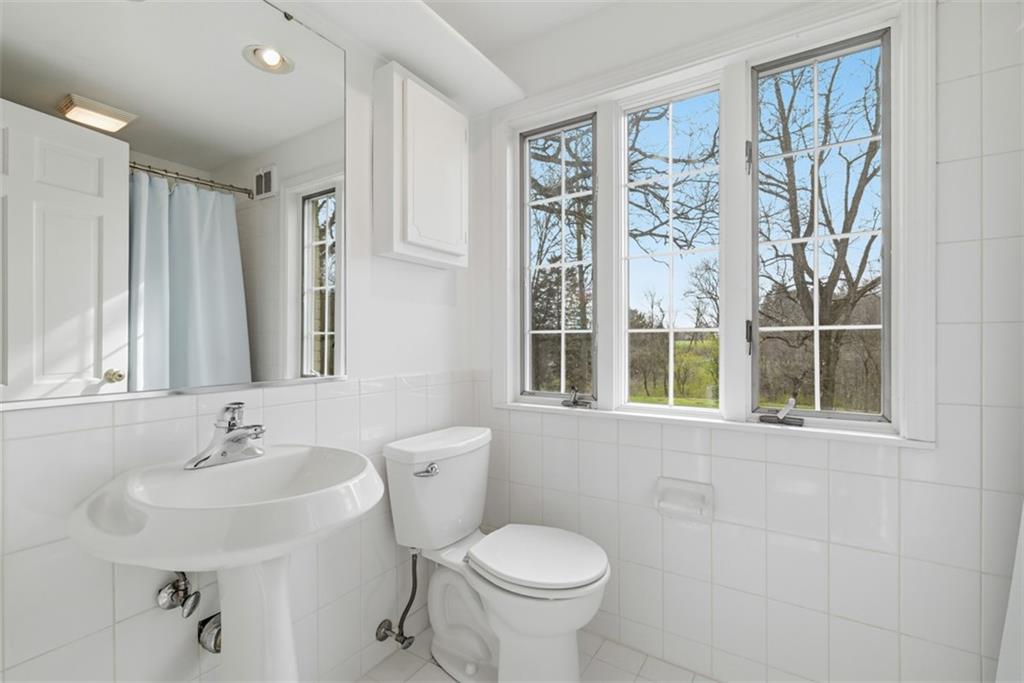 1001 Fox Chapel Road Pittsburgh, PA 15238 - Photo 43 of 50 a bathroom with a sink toilet and a mirror