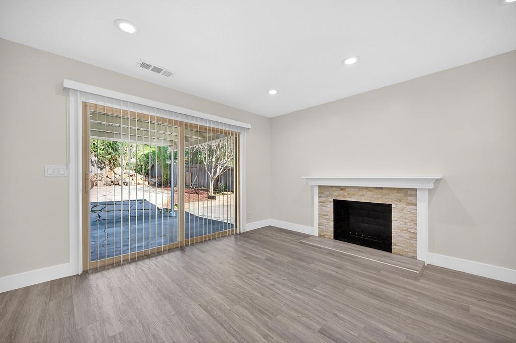 7517 Farmgate Way Citrus Heights, CA 95610 - Photo 12 of 35 wooden floor fireplace and natural light in room