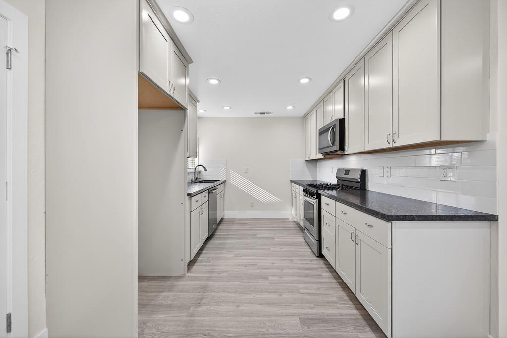 7517 Farmgate Way Citrus Heights, CA 95610 - Photo 15 of 35 a kitchen with granite countertop a sink and cabinets