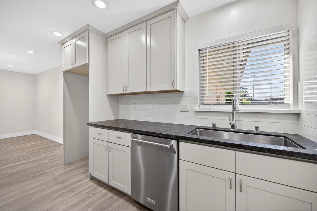 7517 Farmgate Way Citrus Heights, CA 95610 - Photo 18 of 35 a kitchen with granite countertop white cabinets and a sink