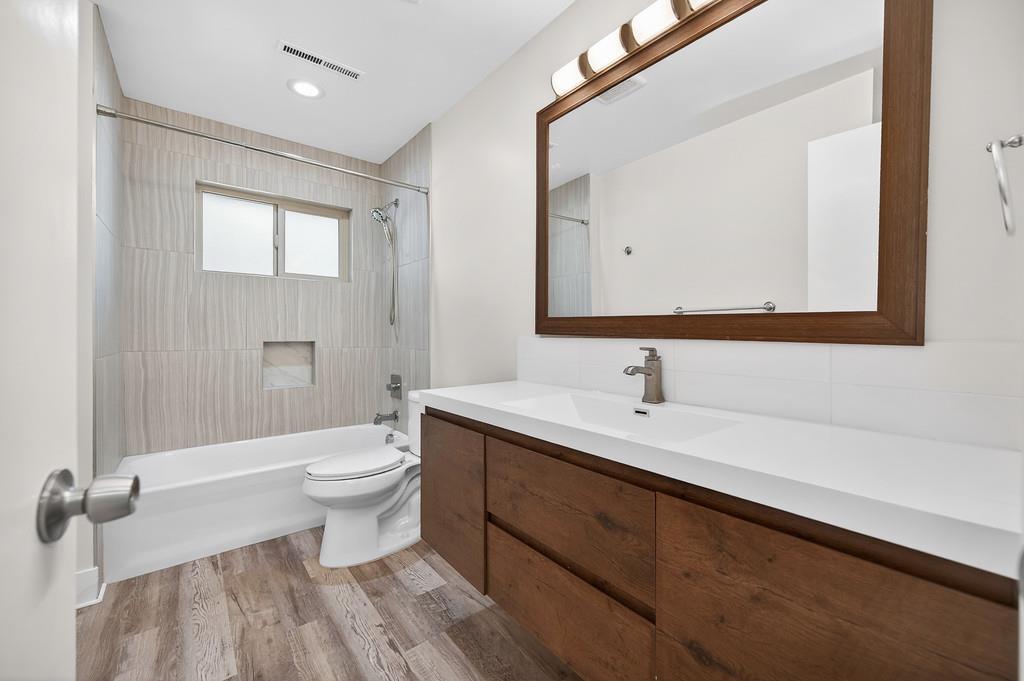 7517 Farmgate Way Citrus Heights, CA 95610 - Photo 23 of 35 a bathroom with a sink a toilet and a large mirror