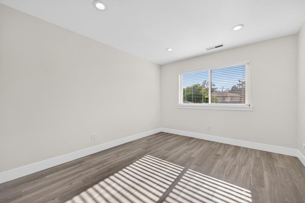 7517 Farmgate Way Citrus Heights, CA 95610 - Photo 24 of 35 an empty room with wooden floor and windows