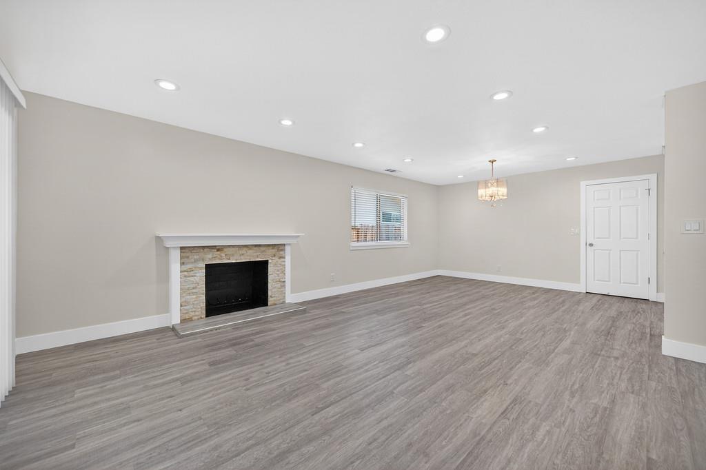 7517 Farmgate Way Citrus Heights, CA 95610 - Photo 9 of 35 an empty room with wooden floor fireplace and windows
