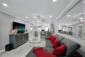 a living room with furniture kitchen area and a fireplace