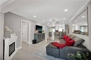 a living room with furniture and kitchen view
