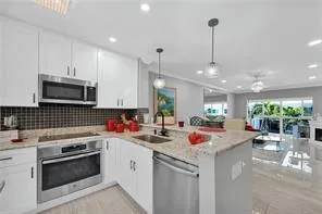 a kitchen with a sink stove and refrigerator