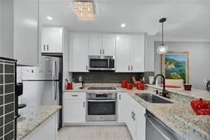 a kitchen with a sink stove and refrigerator