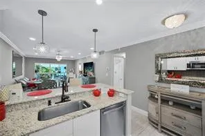 a living room with furniture a dining table and a potted plant