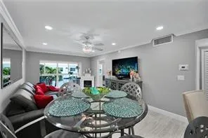 a dining room with furniture and a chandelier