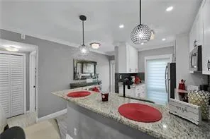 a living room with furniture a fireplace and a potted plant