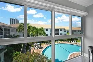 a kitchen with a refrigerator and white cabinets