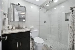 a bedroom with a bed and a ceiling fan