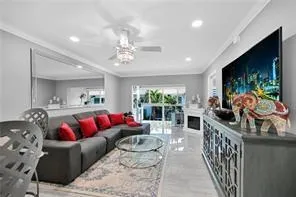 a living room with furniture a flat screen tv and a large window