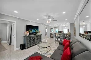 a living room with furniture a flat screen tv and a table