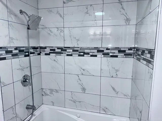 a bathroom with a bathtub and shower