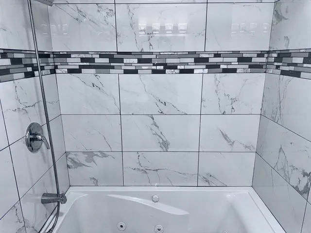 a bathroom with a bathtub and shower