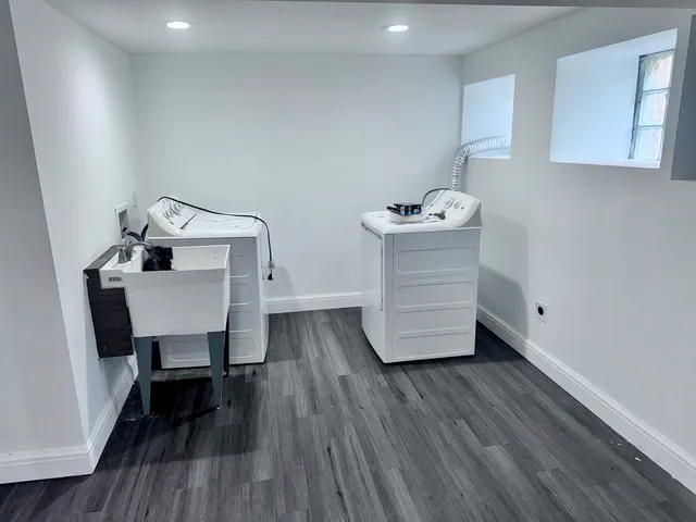 a room with a table chairs and wooden floor