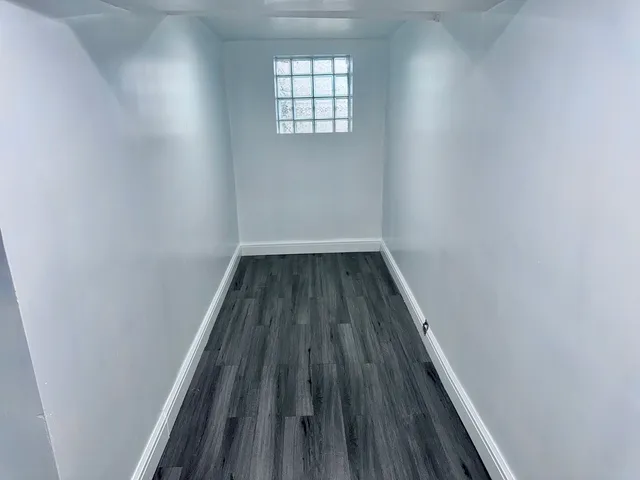 a view of wooden floor in a hallway