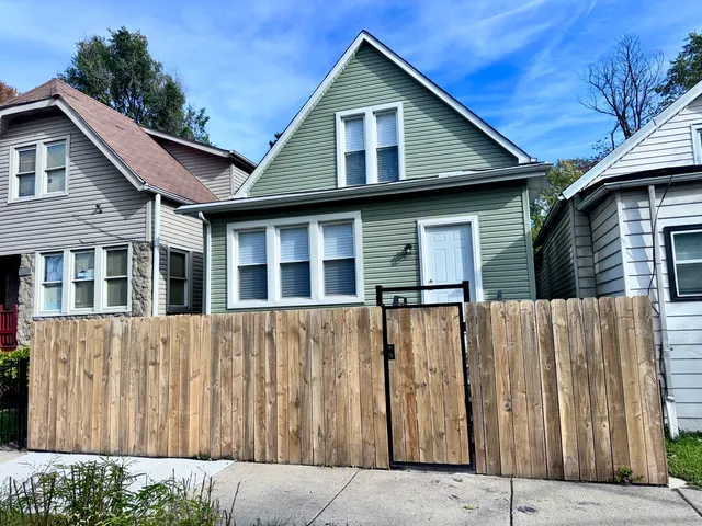 a front view of a house with wooden fence