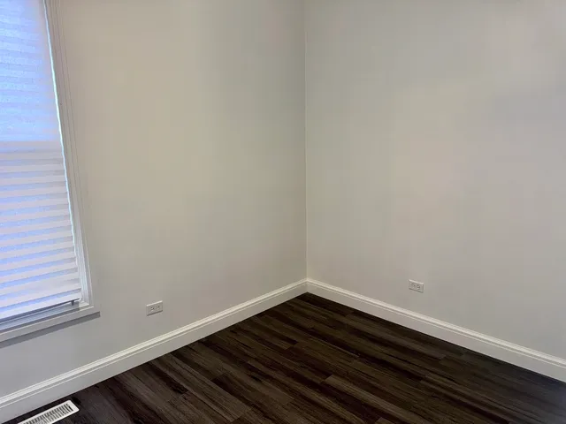 a room with wooden floor and window