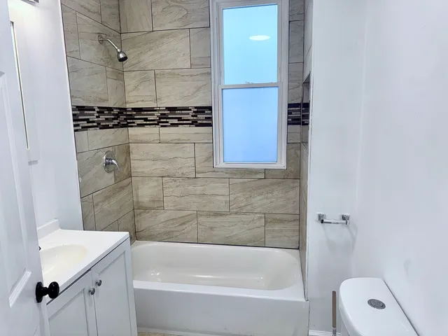 a bathroom with a sink a toilet and bathtub