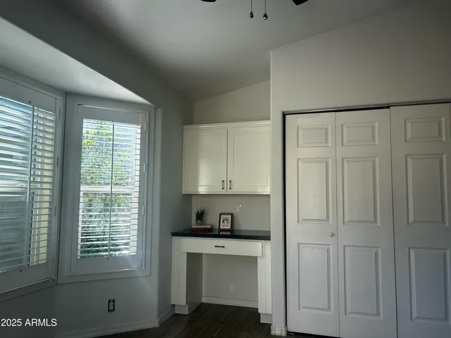 a view of kitchen with granite countertop cabinets next to a window