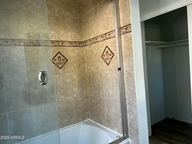 a bathroom with a shower and a sink