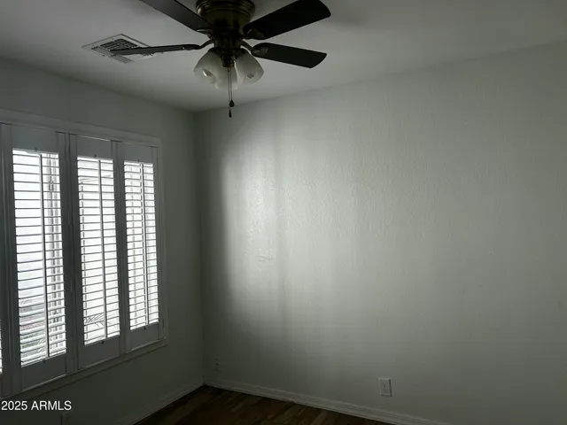 a small space with a window and a fan