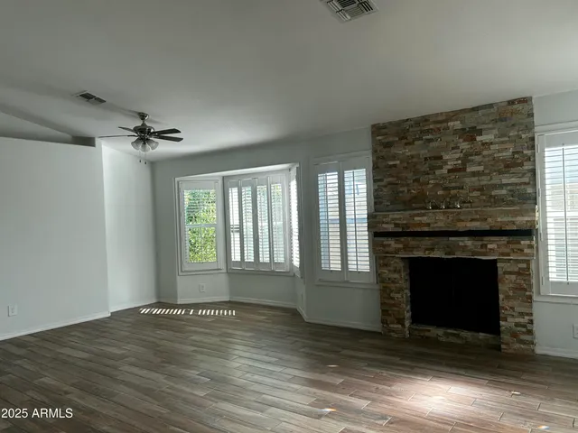 a view of an empty room with a fireplace and a window