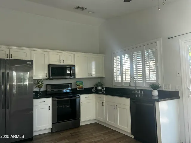 a kitchen with a sink stove and refrigerator