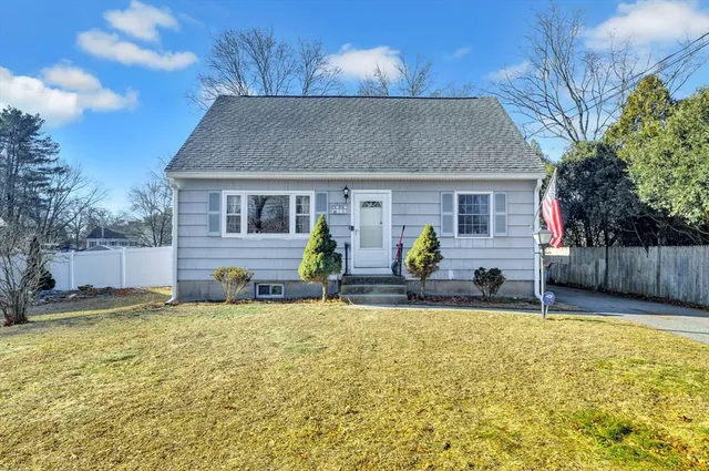 a view of a house with patio and a yard