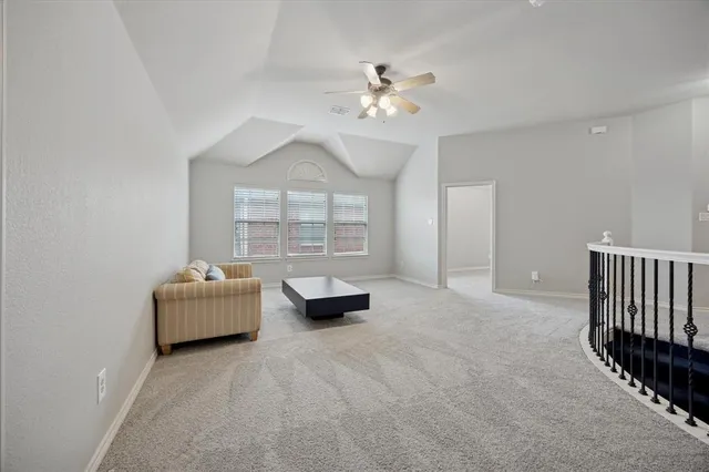 a living room with furniture chandelier and a window