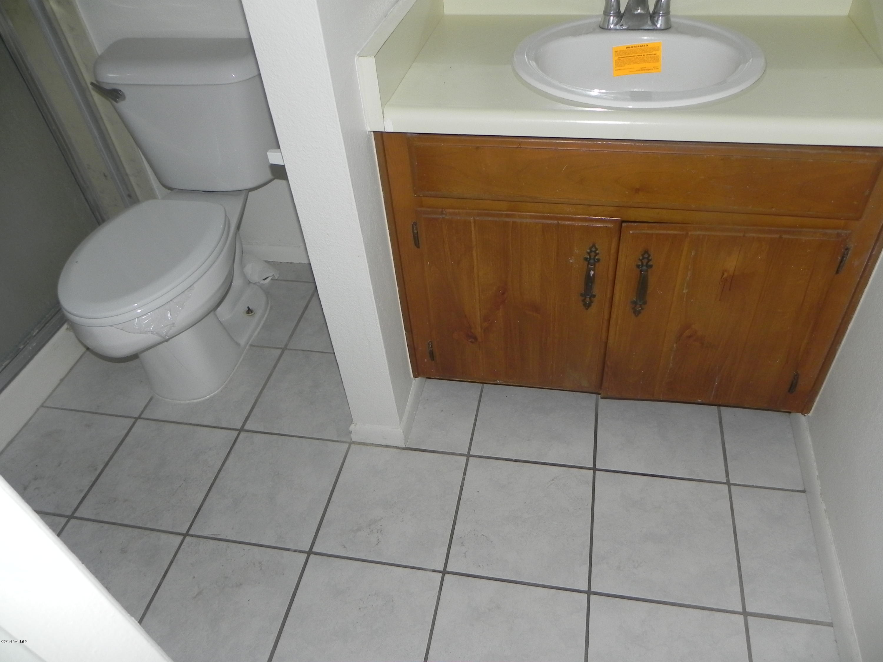 6625 East Golf Links Road, Unit 2 Tucson, AZ 85730 - Photo 7 of 14 a bathroom with a toilet and a sink
