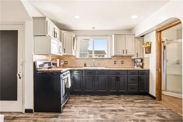 a kitchen with stainless steel appliances granite countertop a refrigerator sink and cabinets