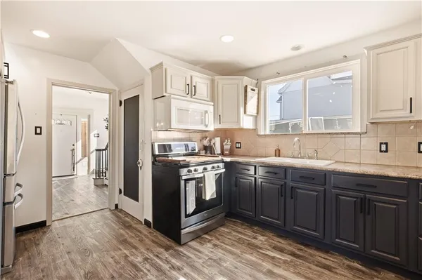 a kitchen with stainless steel appliances granite countertop a stove and a sink