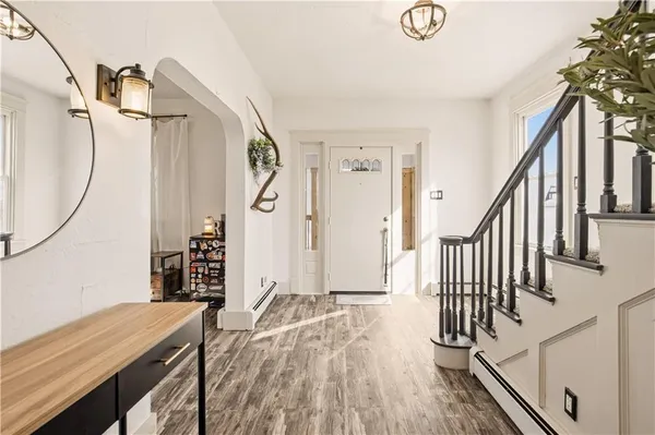 a view of a livingroom with wooden floor and stairs