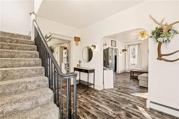 a view of entryway and hall with wooden floor