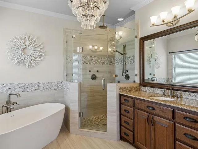 a bathroom with a double vanity sink mirror and shower