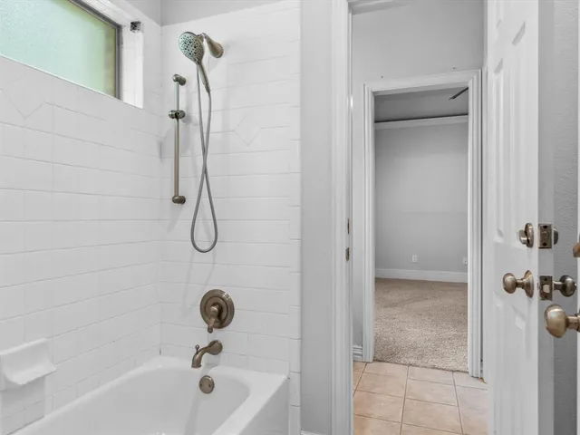 a bathroom with a bath tub with a shower
