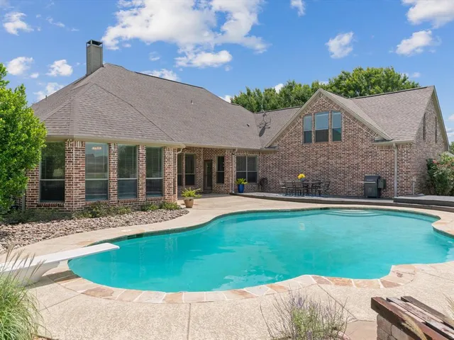 a front view of a house with a garden and patio